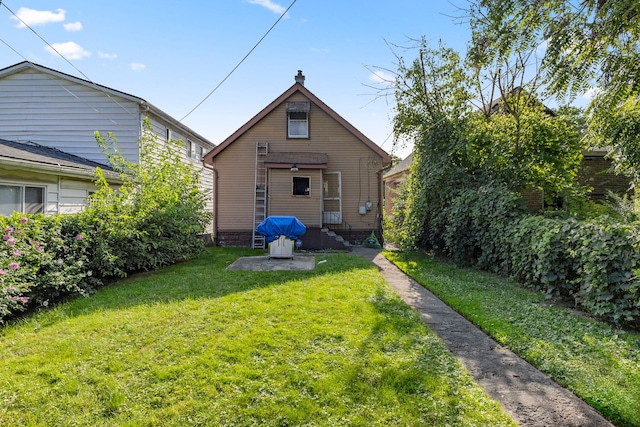 back of house with a lawn