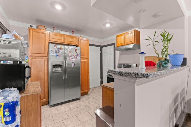 kitchen with kitchen peninsula, stainless steel fridge, and light stone countertops