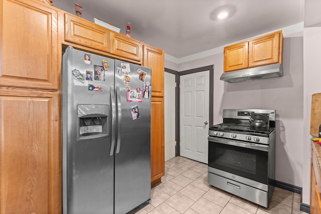 kitchen with appliances with stainless steel finishes, light brown cabinets, and light tile patterned floors