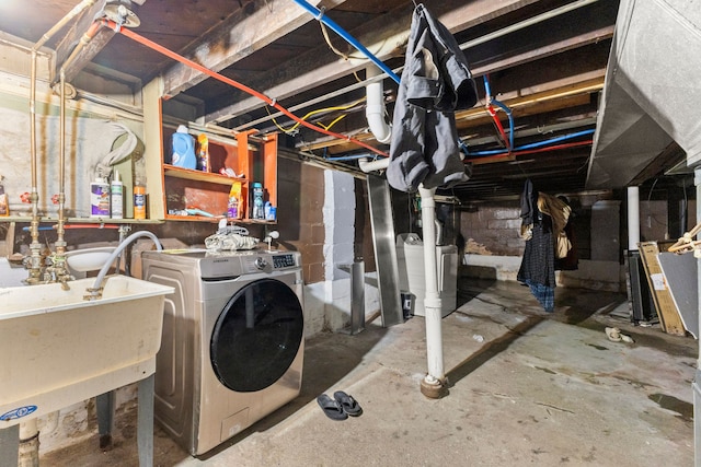 basement featuring sink and washer / clothes dryer