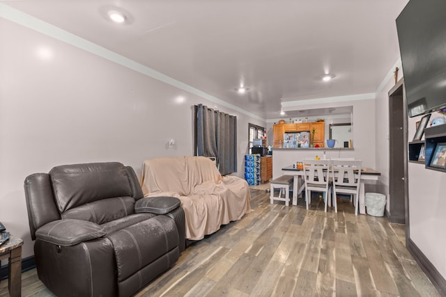 living room featuring crown molding and wood-type flooring