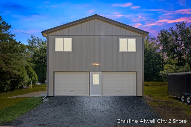 view of garage at dusk