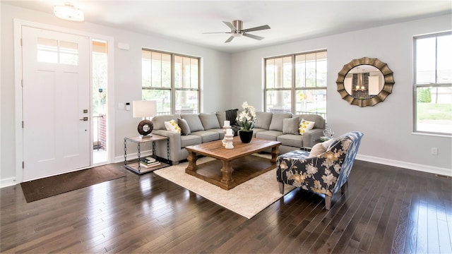 living room featuring dark hardwood / wood-style flooring, ceiling fan, and a healthy amount of sunlight