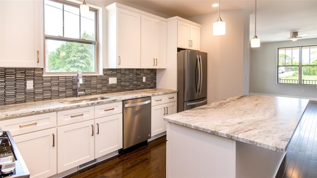 kitchen featuring stainless steel appliances, ceiling fan, dark wood-type flooring, sink, and white cabinets