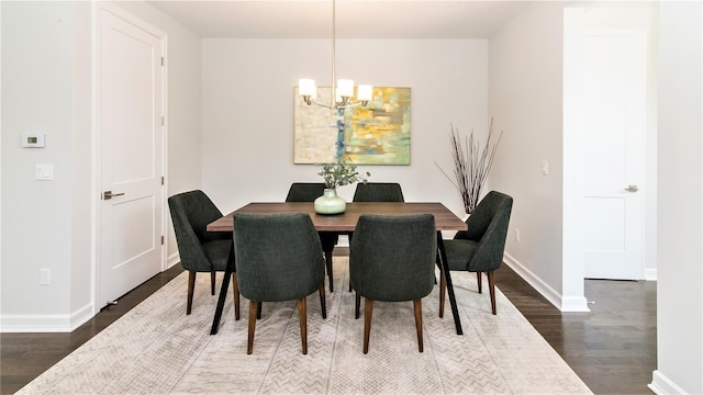 dining room featuring a notable chandelier and dark hardwood / wood-style floors