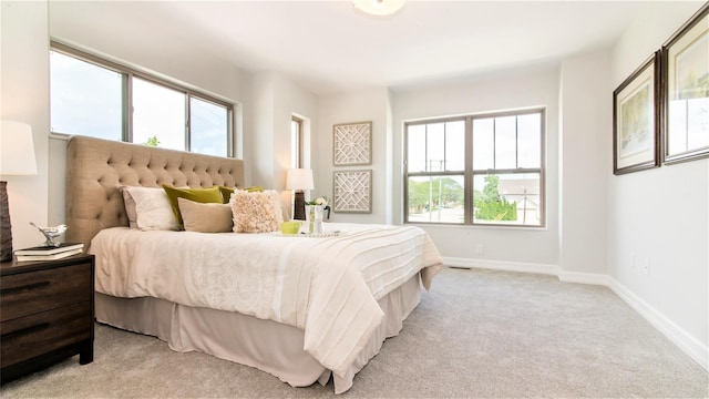 carpeted bedroom with multiple windows