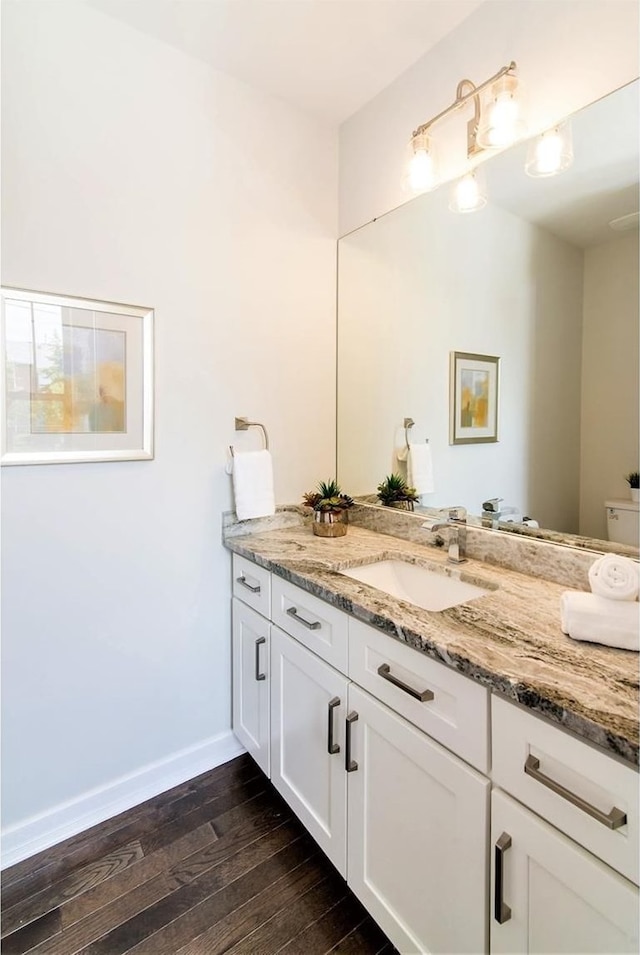 bathroom featuring hardwood / wood-style floors, vanity, and toilet