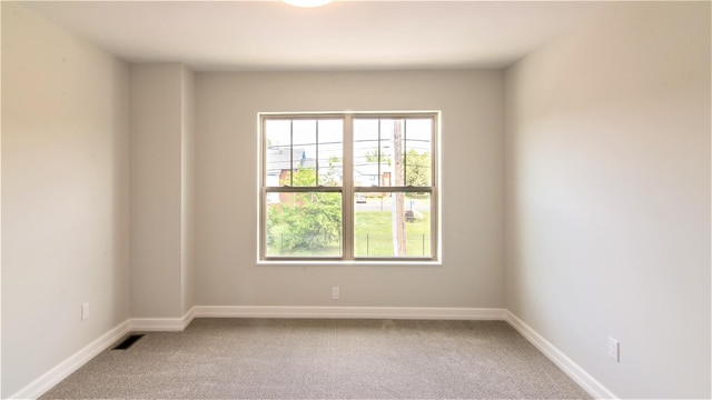 1361 W Canfield St, Detroit, MI 48208 - carpeted empty room with healthy amount of natural light and baseboards