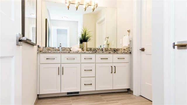 bathroom featuring a chandelier, hardwood / wood-style floors, and vanity