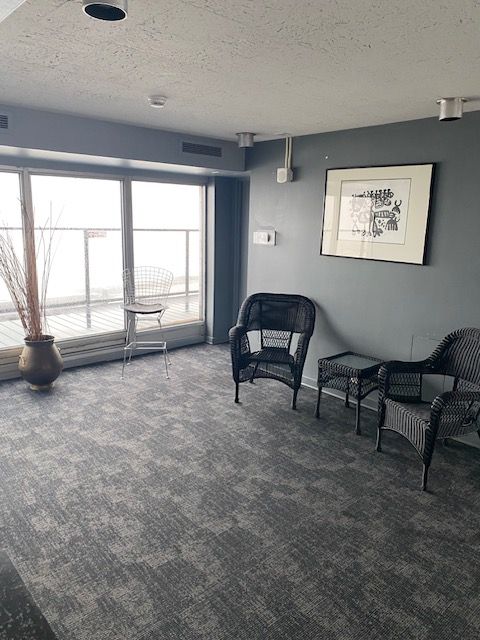 sitting room featuring carpet floors and a textured ceiling