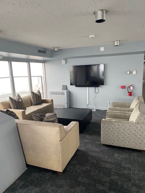 living room with a textured ceiling, dark carpet, and radiator