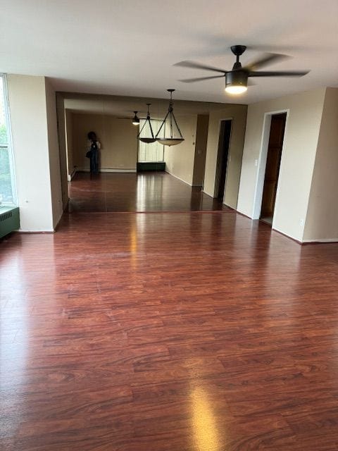 empty room with ceiling fan and dark hardwood / wood-style floors