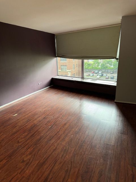 empty room with dark hardwood / wood-style flooring