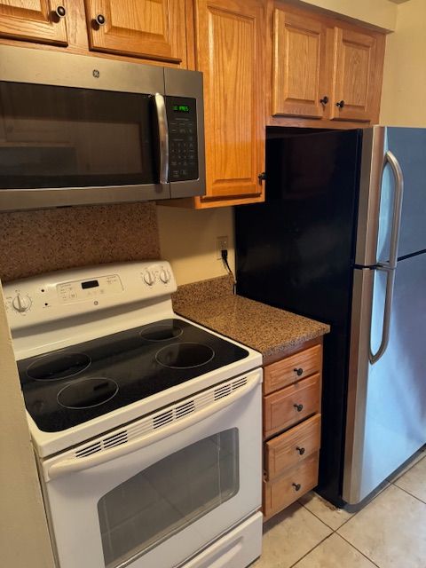 kitchen featuring light tile patterned floors and appliances with stainless steel finishes