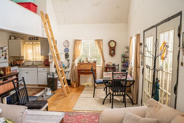 interior space with sink and vaulted ceiling