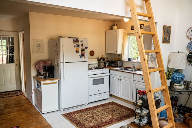 kitchen featuring white cabinets, white appliances, and a healthy amount of sunlight