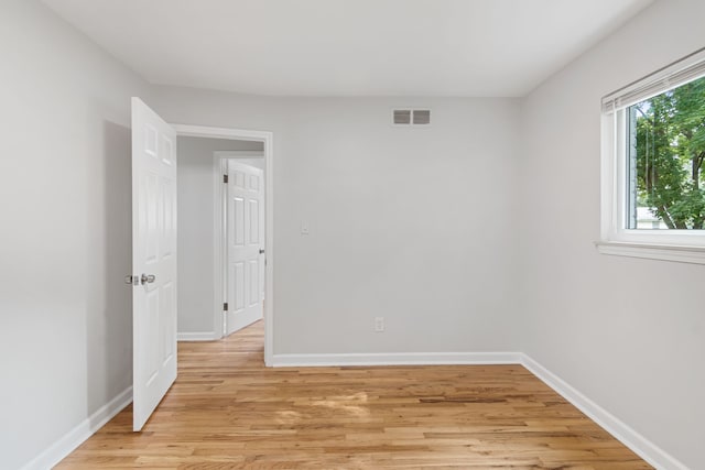 spare room featuring light hardwood / wood-style flooring