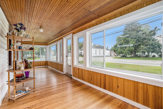 unfurnished sunroom featuring a wealth of natural light and wooden ceiling