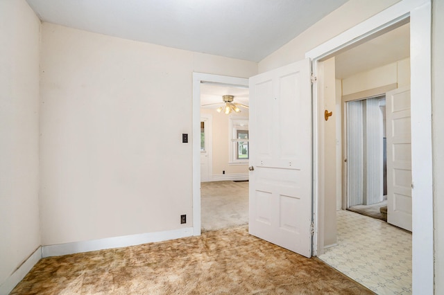 unfurnished room featuring ceiling fan and light carpet