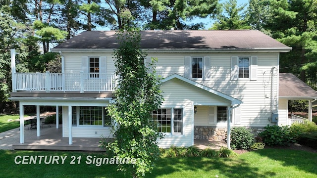 back of house with a lawn and a wooden deck