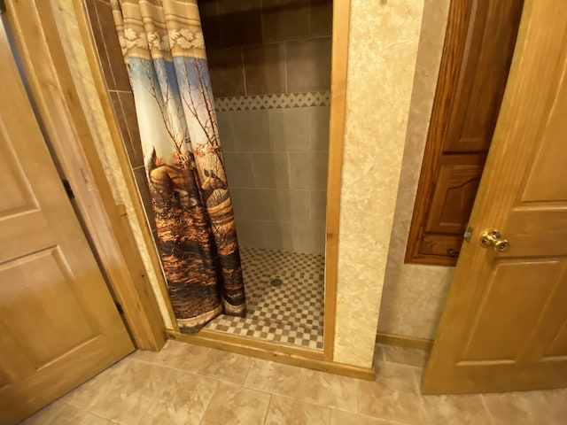 bathroom with tile patterned floors and curtained shower