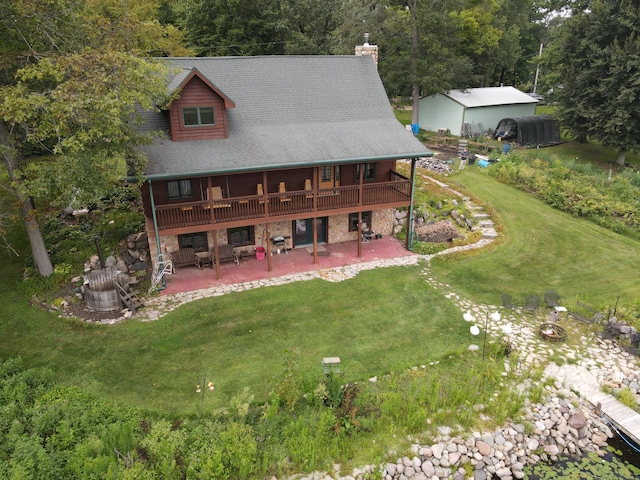 back of property with a yard, a patio, and a wooden deck