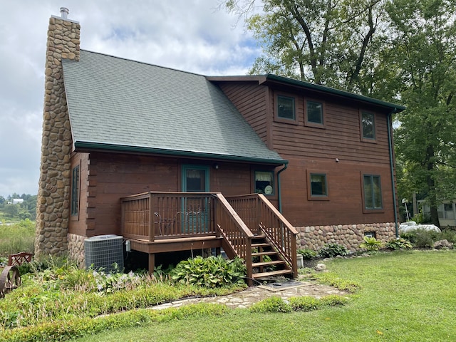 back of property with a yard, central air condition unit, and a wooden deck