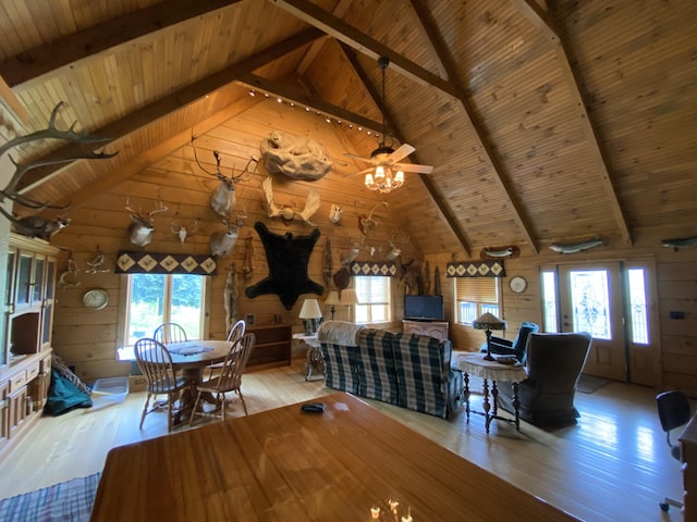 dining room with light hardwood / wood-style flooring, plenty of natural light, and wooden walls