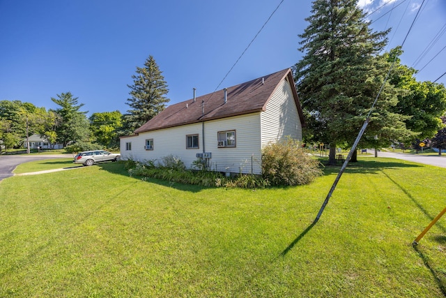 view of property exterior with a yard