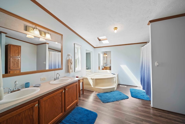 bathroom featuring a washtub, vanity, a textured ceiling, and hardwood / wood-style flooring