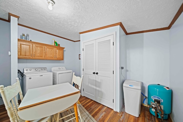 washroom with a textured ceiling, washer and dryer, cabinets, and dark wood-type flooring