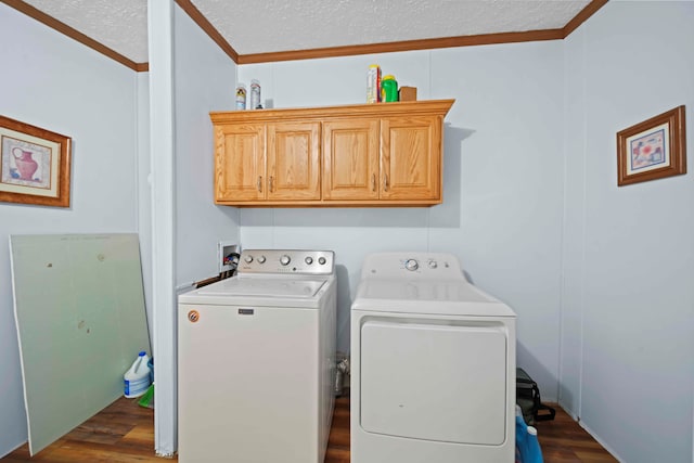 washroom featuring a textured ceiling, cabinets, separate washer and dryer, and dark wood-type flooring