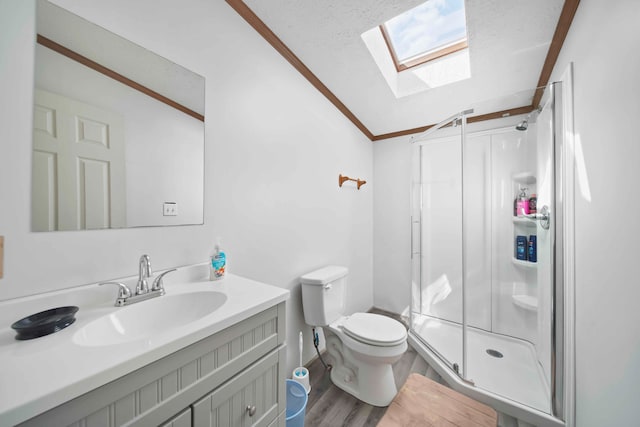 bathroom featuring vanity, lofted ceiling with skylight, wood-type flooring, toilet, and a shower with shower door