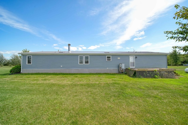 rear view of property featuring a yard