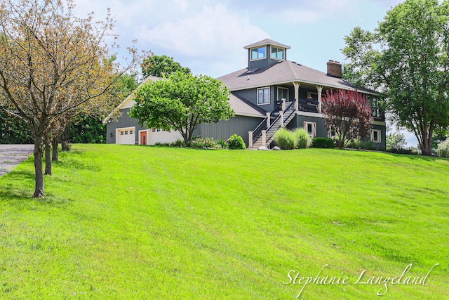 view of front of home with a garage and a front lawn