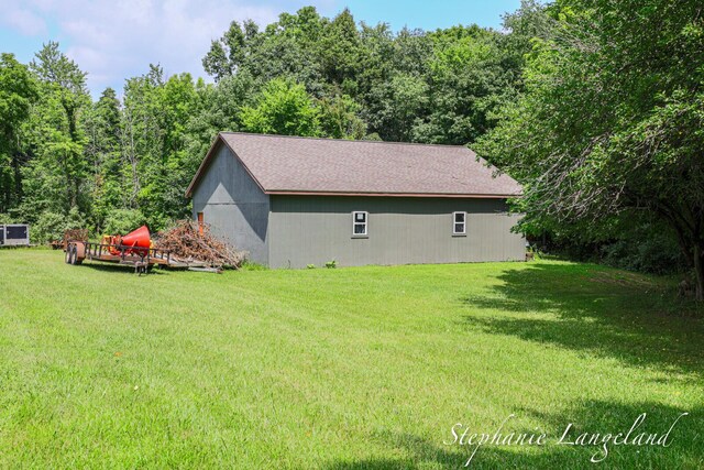 7300 Packer Dr NE, Belmont, MI 49306 - view of home's exterior featuring a lawn and a wooded view