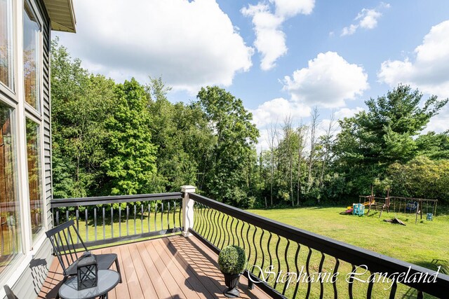 7300 Packer Dr NE, Belmont, MI 49306 - wooden deck with a yard and a playground