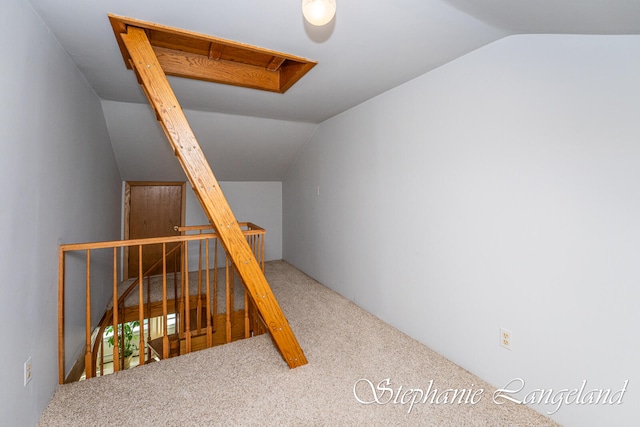 stairs with carpet flooring and lofted ceiling