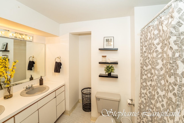 bathroom with tile patterned floors, vanity, and toilet