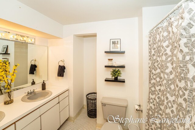 7300 Packer Dr NE, Belmont, MI 49306 - bathroom with double vanity, toilet, tile patterned flooring, and curtained shower
