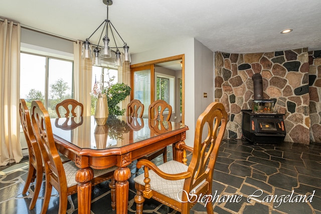 dining space featuring plenty of natural light and a wood stove