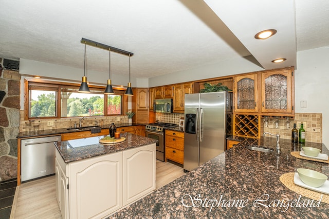 kitchen featuring sink, light wood-type flooring, and stainless steel appliances