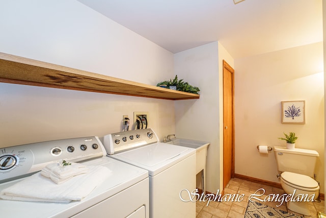 clothes washing area featuring independent washer and dryer and light tile patterned flooring