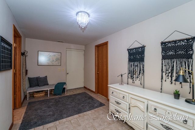 tiled foyer with a chandelier