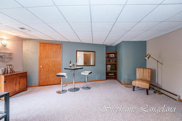 7300 Packer Dr NE, Belmont, MI 49306 - living area with a baseboard radiator, carpet, baseboards, and a drop ceiling