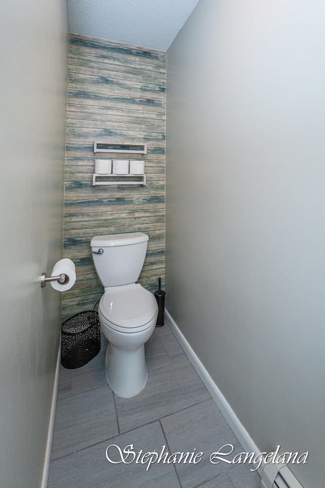 bathroom featuring a textured ceiling and toilet