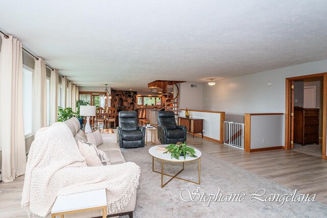 7300 Packer Dr NE, Belmont, MI 49306 - living area featuring wood finished floors, a chandelier, and baseboards