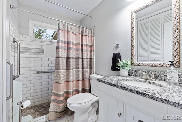 bathroom featuring a shower with curtain, vanity, toilet, and tile patterned floors