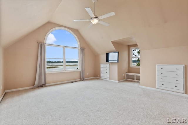 bonus room with ceiling fan, light carpet, and lofted ceiling