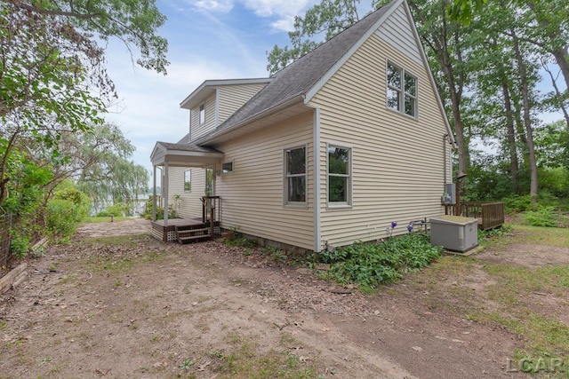 view of side of property featuring a wooden deck